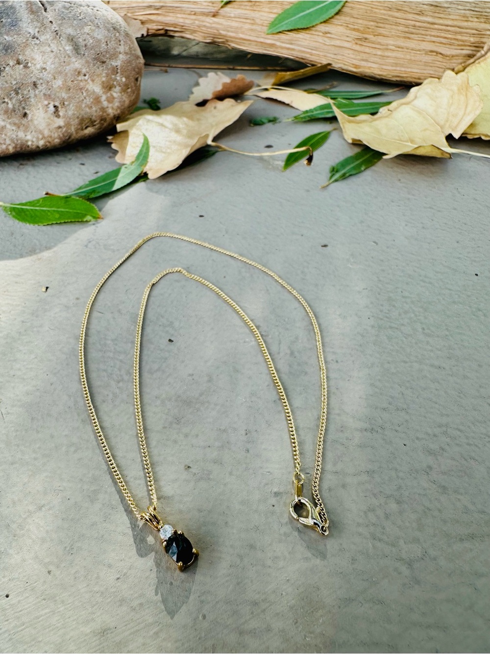 Gold Tone Necklace with Black and Clear Stone Pendant